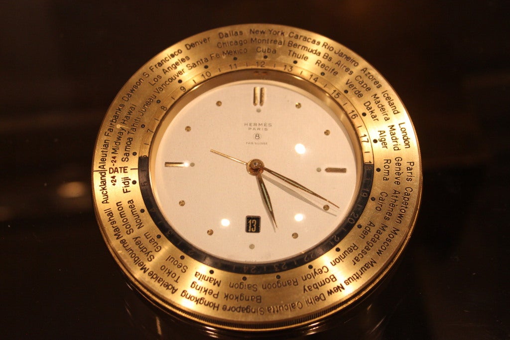 Up for sale is a nearly mint condition of an hermes World Time clock. This clock also has other features such as a calendar and alarm. This is a great bedside table clock or certainly a clock to travel with.