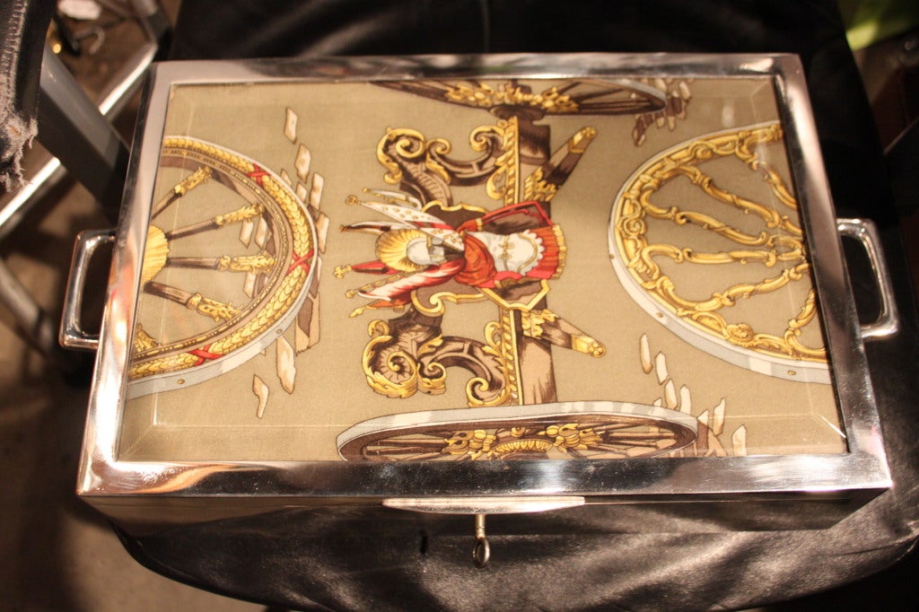 Super rare Hermes Humidor with a glass top on top of a silk fabric . This was probably a custom ordered Piece. The handles move up and down. Its amazing quality as one would expect from Hermes