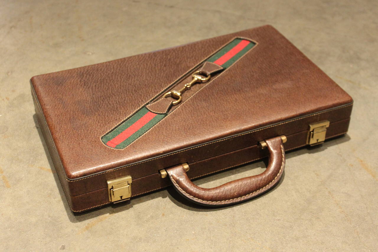 This amazing Gucci Backgammon set is from the early 1970s and is in perfect condition. The board is made of wood and the case is all leather. It's a great size for travel.