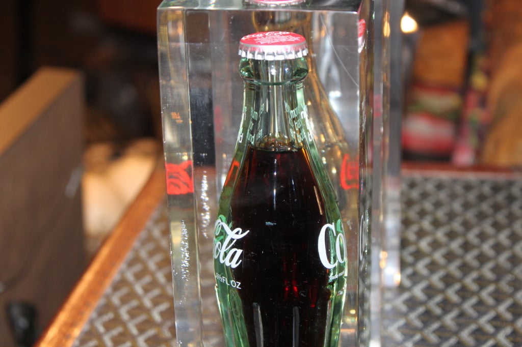 This is a collection of real coke bottle embedded in lucite. Very cool objects.