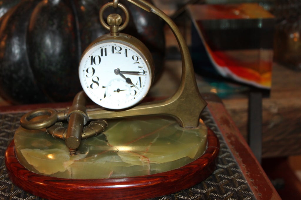 We sell many of these Ball clock or paperweight clocks as they are sometimes referred to. This on comes on a magnificent bronze holder representing a Nautical motif .The clock which has an 8 day movement that works perfectly, The enamel dial is in
