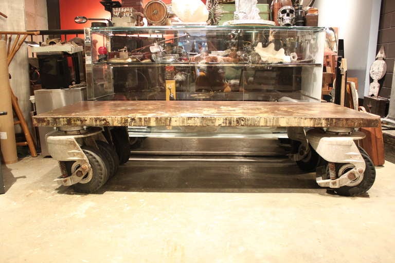 A amazing coffee table created from a custom sized sheet of steel and giant industrial wheels