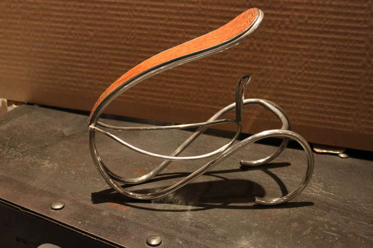 This is a very unusual example of this item. The metal is silver plate and the handle is inset with beautiful honey colored alligator.The bottom is signed Hermes Paris