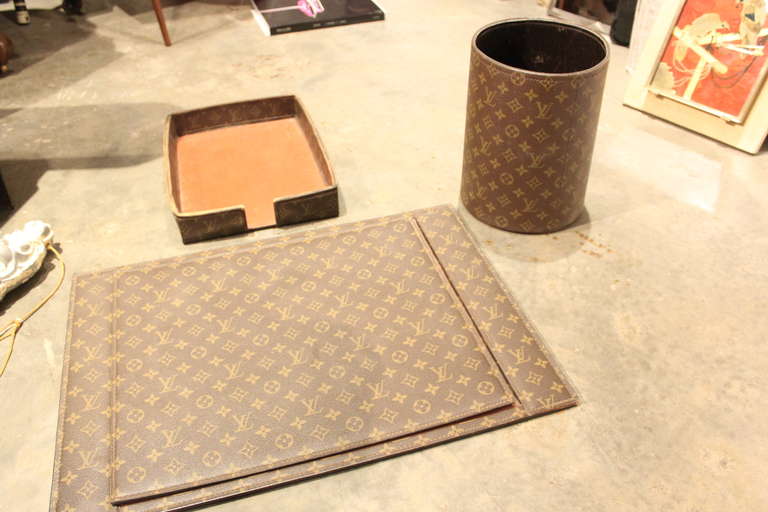 This is a rare louis Vuitton desk set. It includes a desk blotter ,paper tray and trash can.