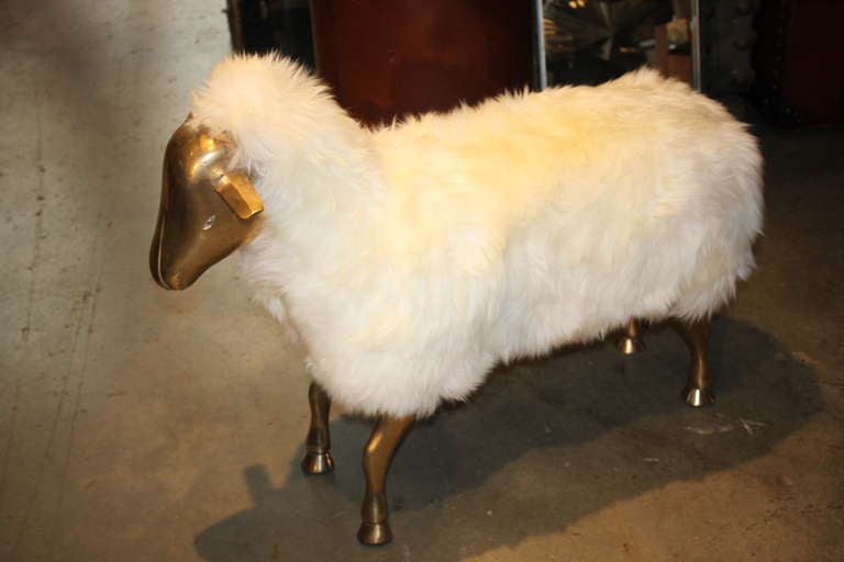 This Wonderful 70's French Stool is super high quality in the style of Lalanne. The stool is solid bronze and is wrapped in sheep skin. Such a cool object