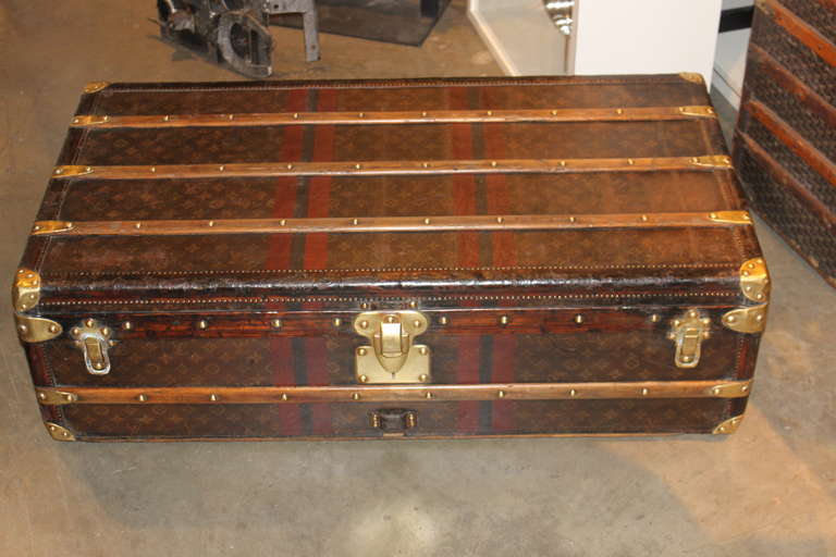 This is a fabulous 1930s Louis Vuitton trunk. This size trunk is the most sought after for use as a coffee table. This one was lovingly used and has developed a wonderful patina. The personalized monogram and striping add a distinguished flavor to