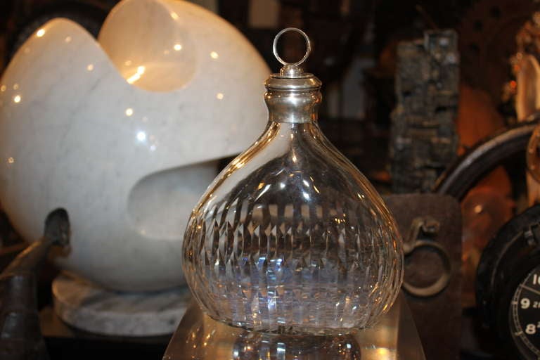 This Cartier decanter is  made for the french market. The Rim  has French silver touch marks and the glass is Baccarat. Its super quality as you would expect from Cartier