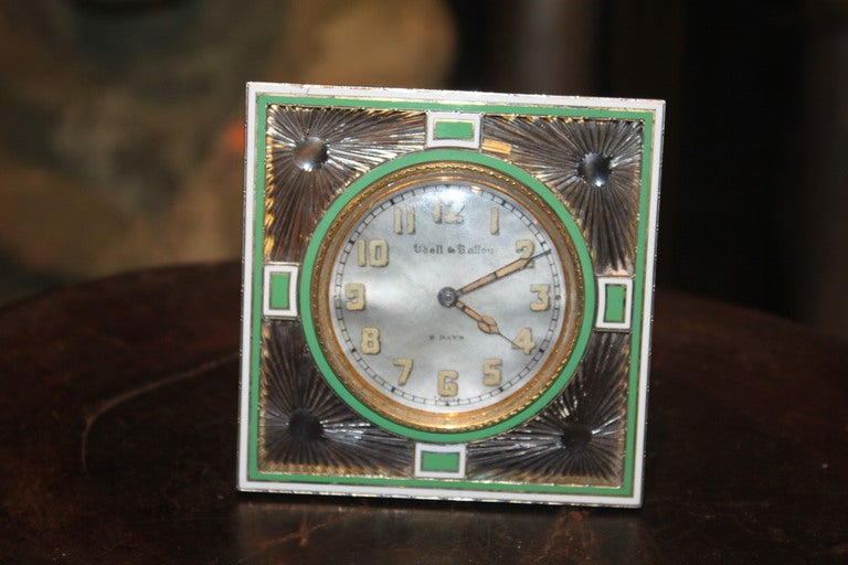 This clock is an object of virtue. It face is made of mother of pearl and has a crystal ,sterling and enamel Frames. The clock was retailed by Udall & Ballou which was avery high end retailer in the US. But the clock was made in France.