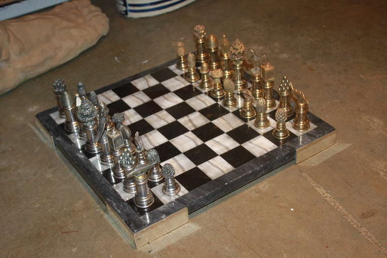 This is the finest and most precious chess set we have handled. The pieces are solid silver weighing several pounds. The tallest piece are 4 inches high. The board is alternating squares of black and grey onyx. The corners are massive silver. The