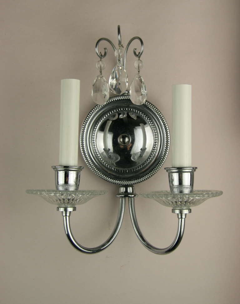 A pair of double light nickel and crystal sconce dressed with crystal drops.