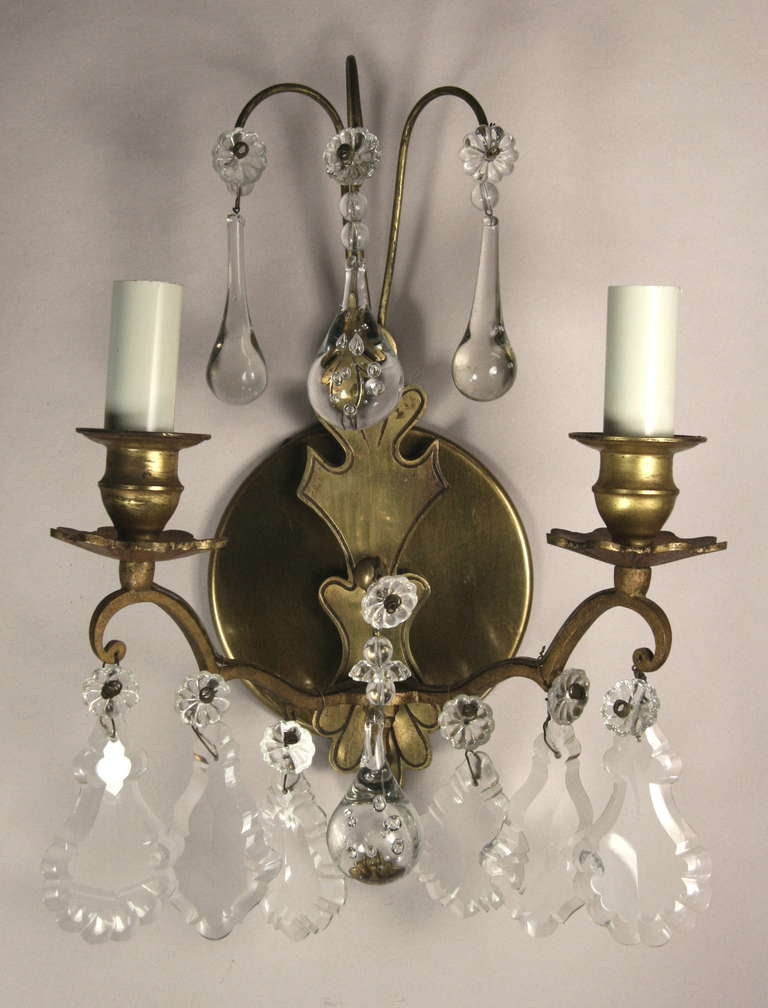 #2-1738 a. A pair of 1950s double arm brass sconce dressed with crystal balls and pendalogu