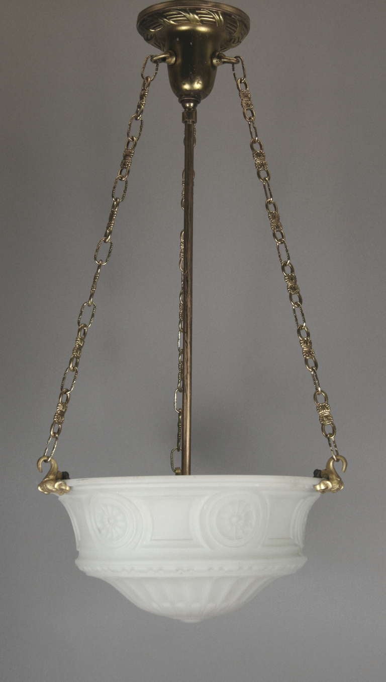 A 1910s embossed cast glass dome suspended by a brass gold chains.
Two available priced individually.

Height is adjustable.