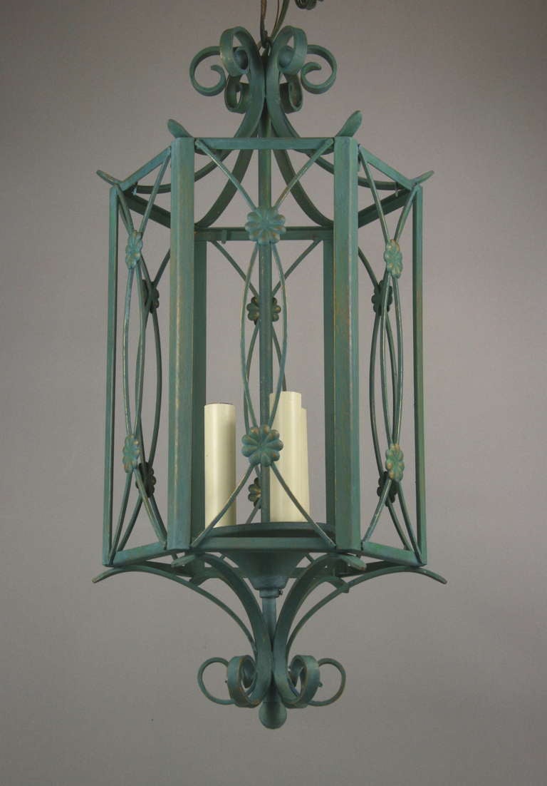 #1-2887, a verdigris finish six panels lantern. Each panel has an open grill work with applied floral roundels.
Take 3 60 watt candllabra based bulbs