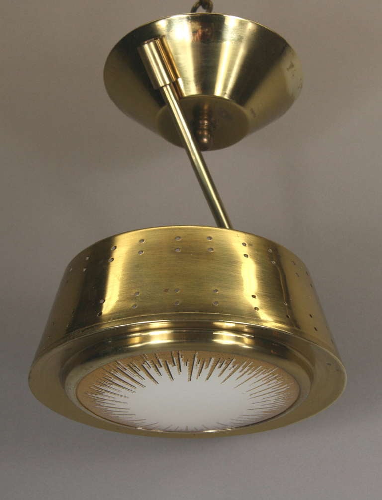 #1-2890, a brass asymmetrical pendant or flush mount ceiling fixture having a sunburst glass lenses at the bottom.
Single light.75 watt max