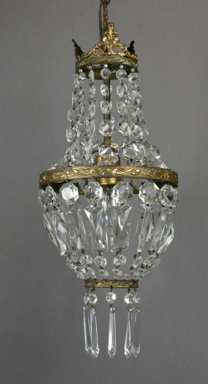 #1-2341, a petite beaded crystal basket in its original aged brass patina. One internal 100 watt Edison bulb.
ON SALE no additional discounts