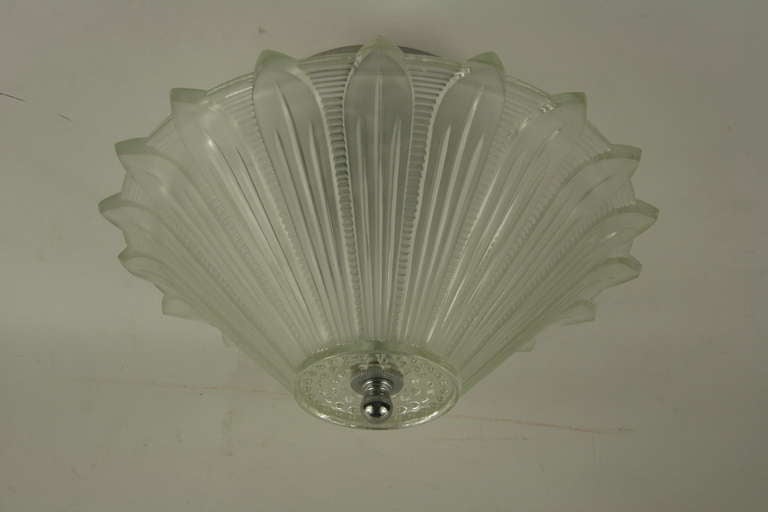 A sunburst glass flush mount having two internal 60 watt Edison bulb.