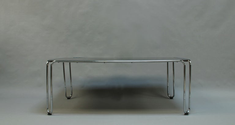 French modernist tubular chrome base table with a black opaline glass top.