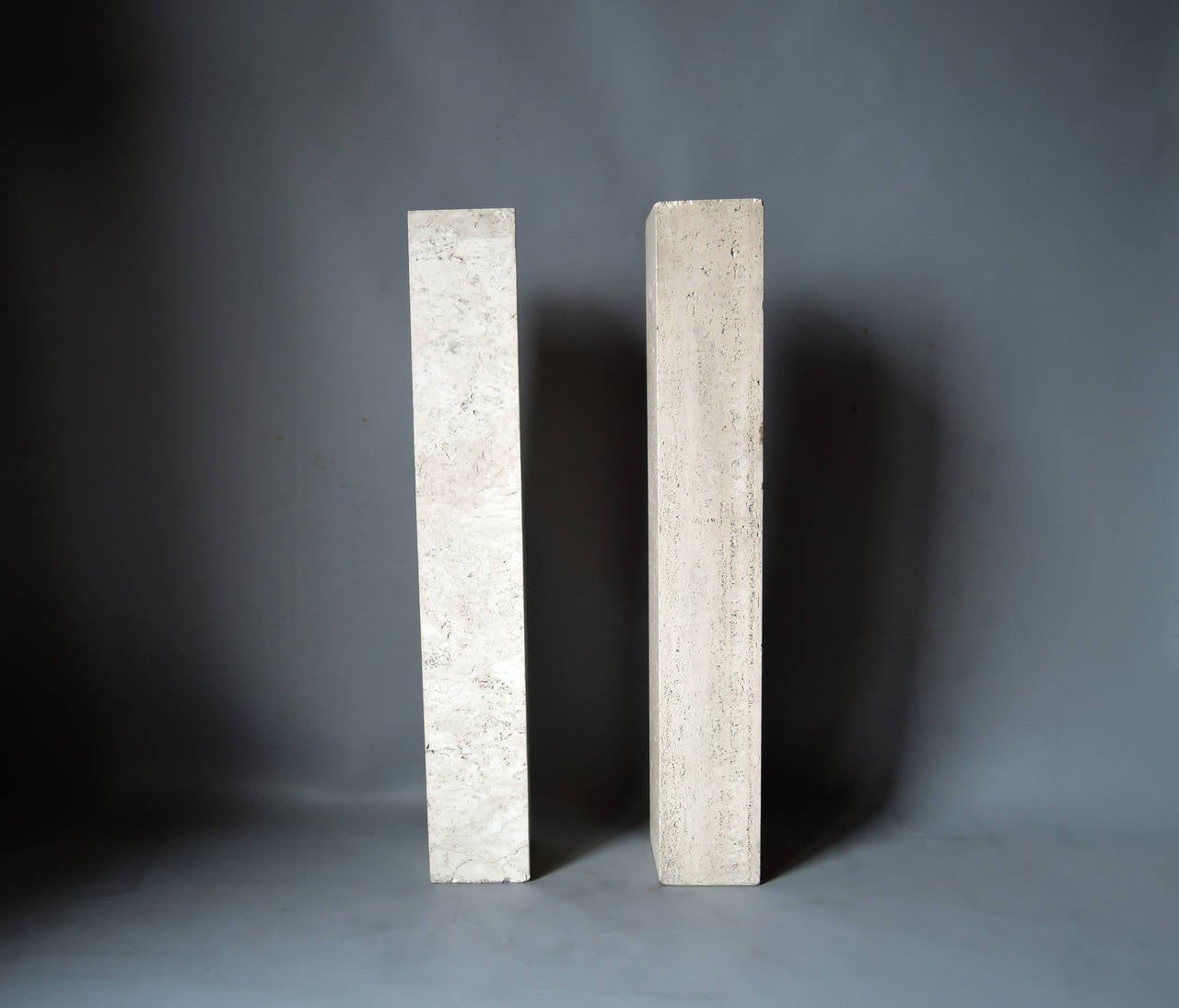 A pair of fine French Art Deco travertine pedestal in the manner of Marc du Plantier.
Two holes on top to insert sculptures or lamps.
There are very small difference in dimensions between the two pedestals.
 