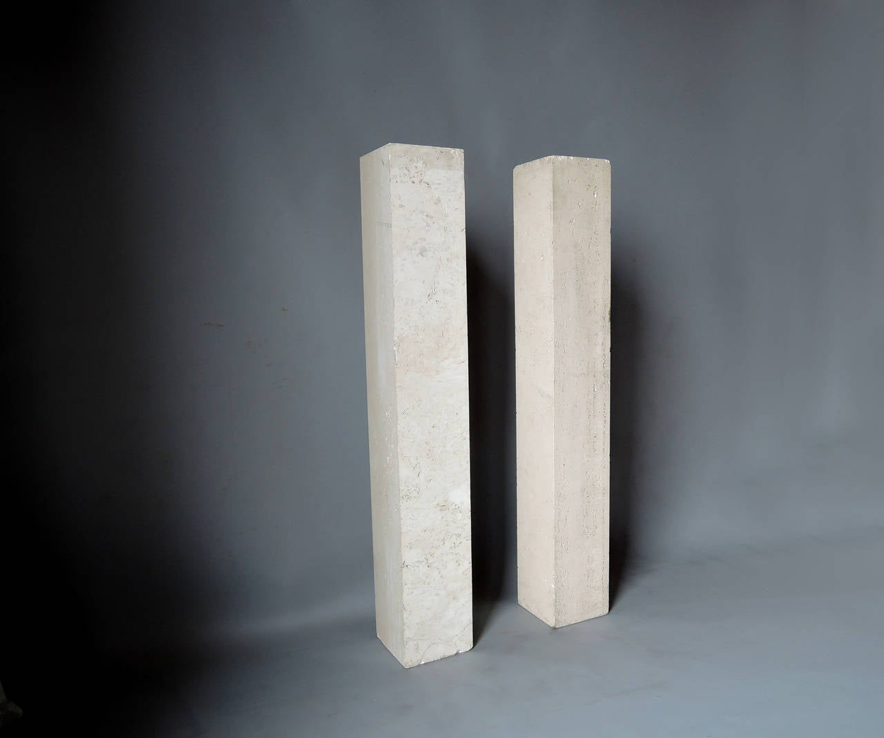 Mid-20th Century A pair of French Art Deco Travertine Pedestals in the Manner of Marc du Plantier