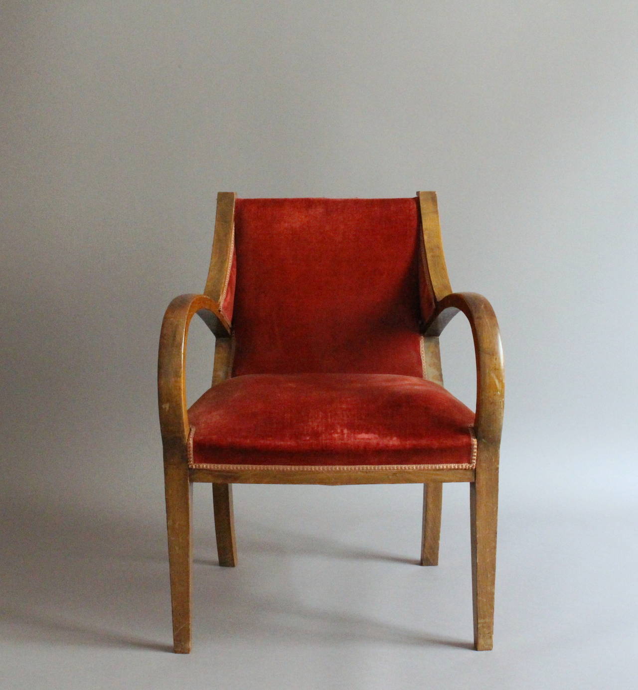 A pair of unusual French Art Deco beechwood bridge armchairs.