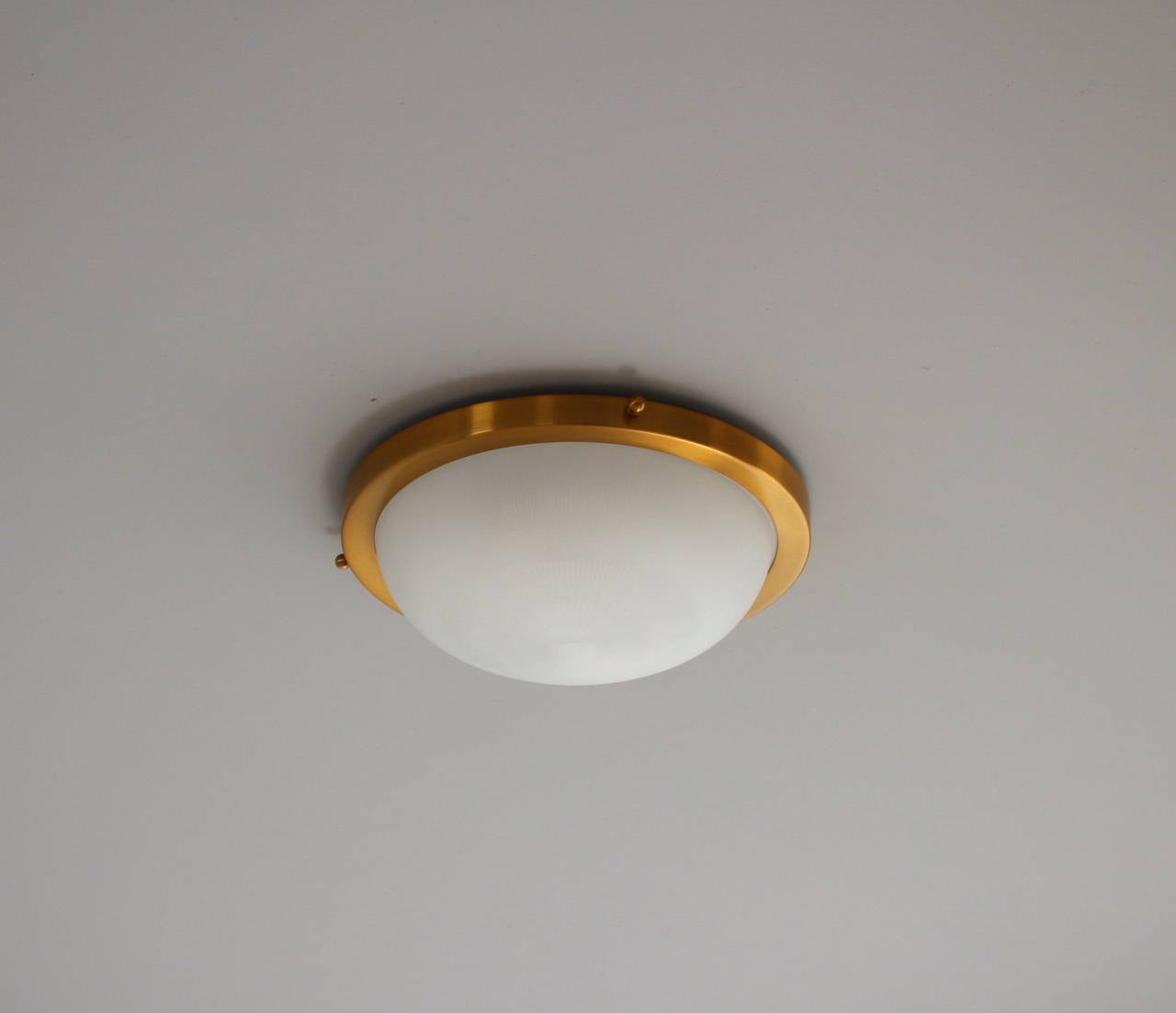 French Art Deco round brushed brass and fluted frosted glass flush mount fixture by Perzel.
Model 539 E.
