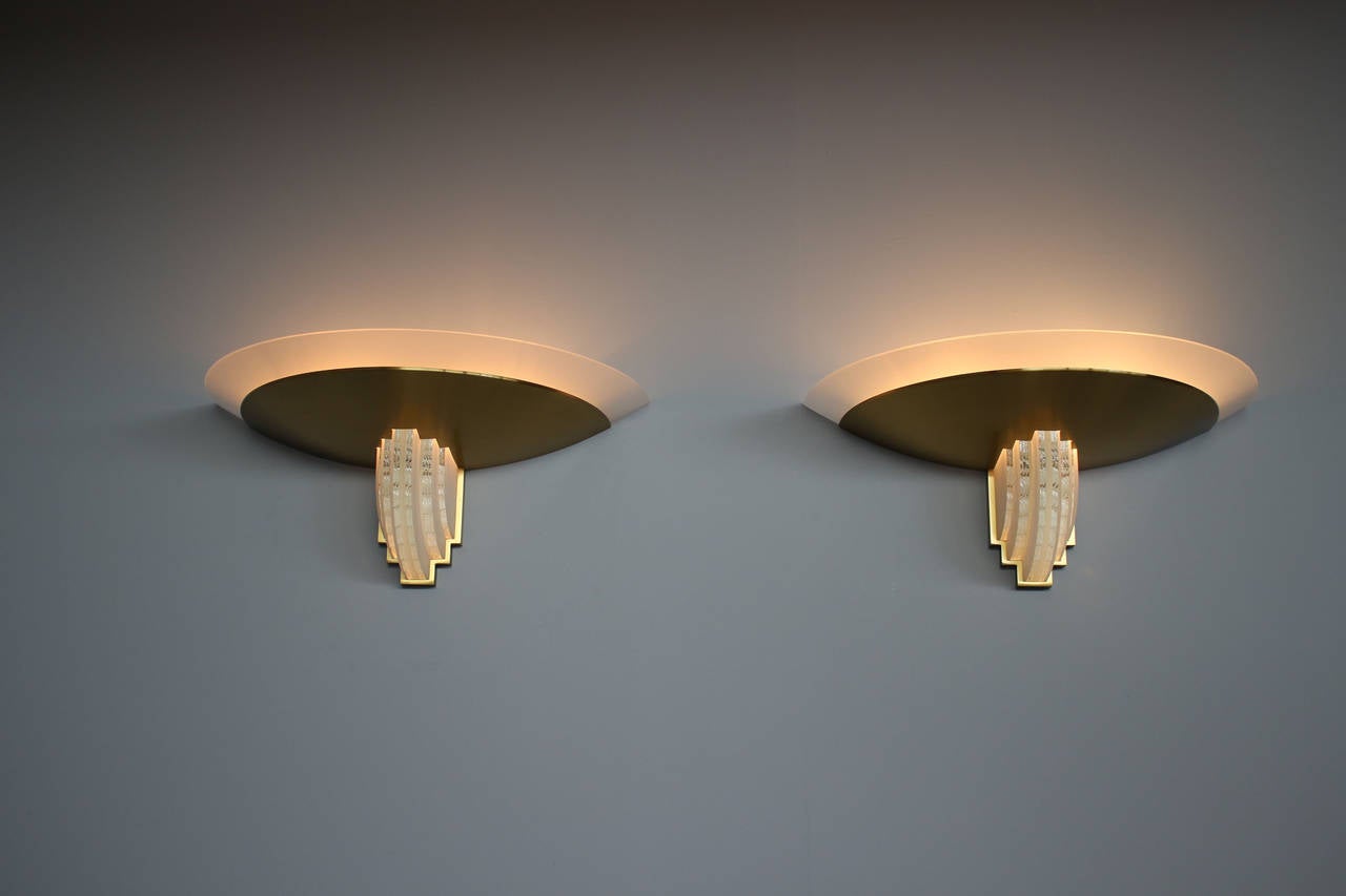 Fine pair of French Art Deco brass framed sconces with some illuminated hand-cut laminae glass on front and a frosted glass shade,
1930s creation - Model 542 bis.
Dealer Ref: 1281