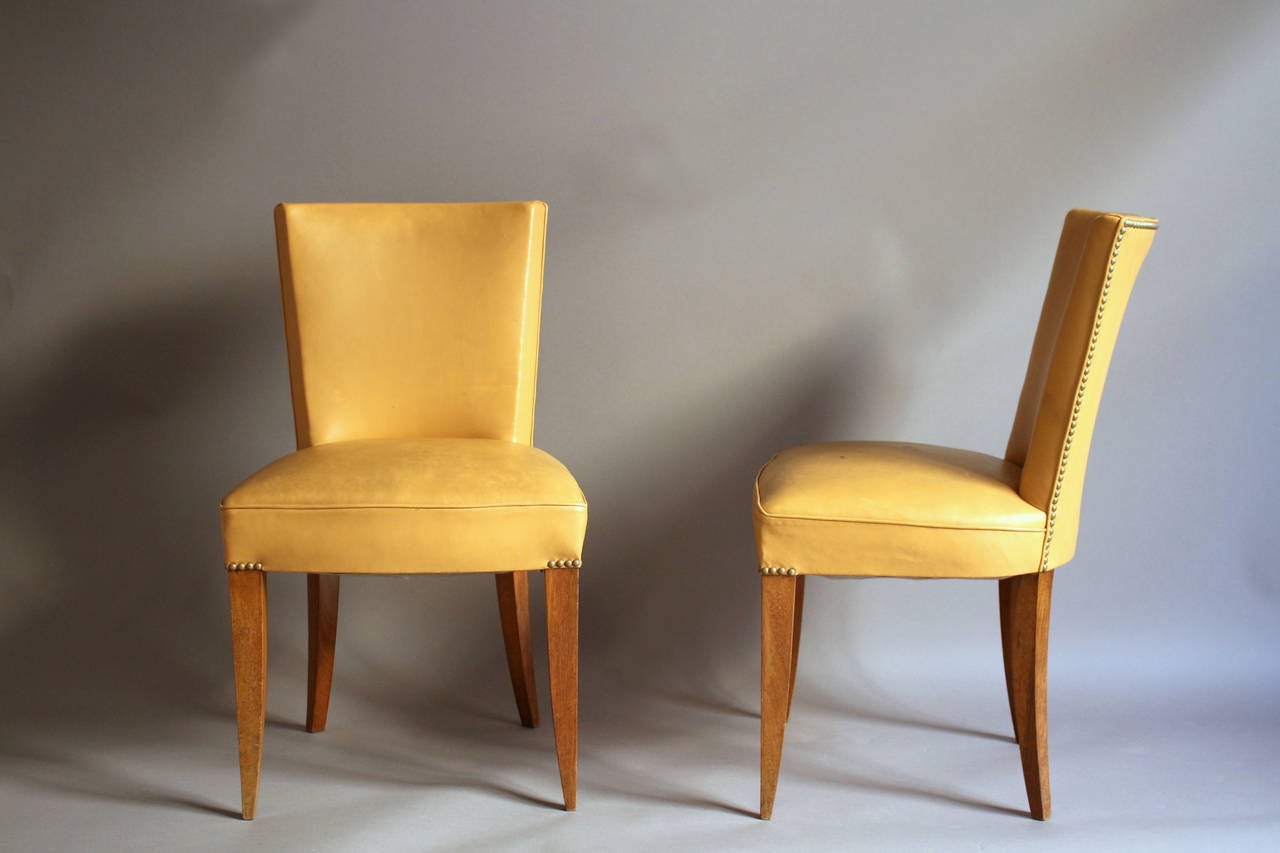 Seven fine French Art Deco mahogany chairs in the manner of Dominique or Adnet.