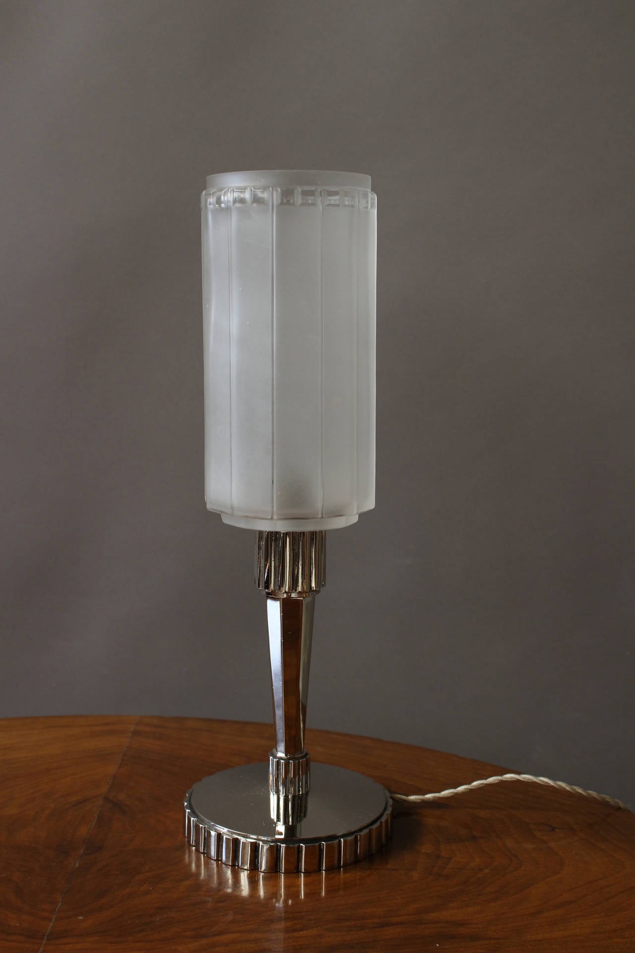 A pair of fine French Art Deco table lamps with a chrome base and a frosted glass shade. 
Signed on the glass.
      