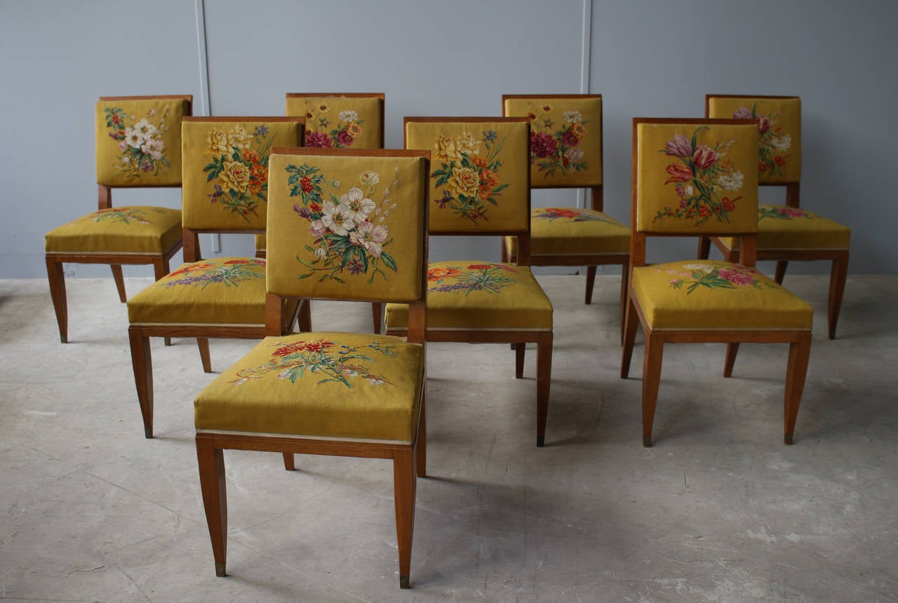 Lucien Rollin - A set of ten fine French Art Deco solid oak dining chairs with bronze sabots  
comprising 8 side and 2 arm chairs.

The pictures have been taken before restoration.
The chairs are now refinished and ready to be re-upholstered with