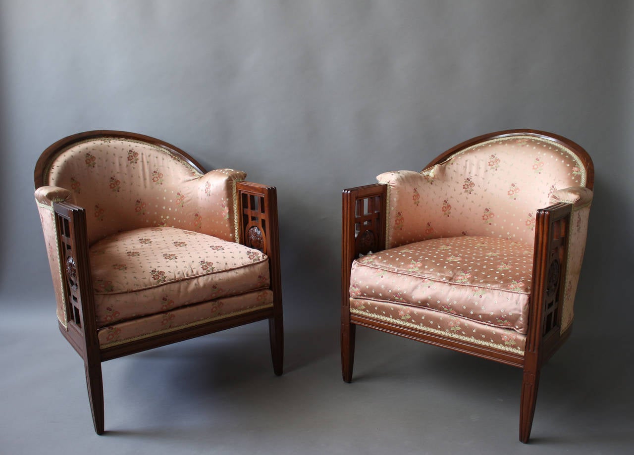 A pair of Fine French Art Deco molded mahogany framed armchairs with a floral carved openwork on the sides, by Paul Follot.
Bibliography: 