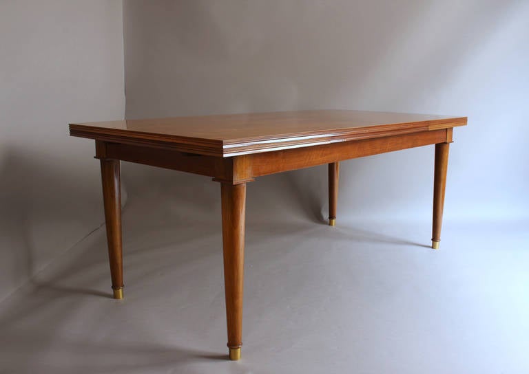 Fine French 1950s walnut dining / writing table with two ends pull-out leaves and bronze details (sabots).
Width is 110