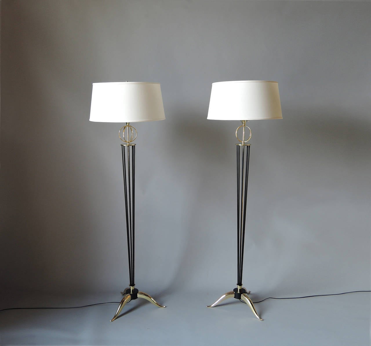 Pair of French 1950s brass and black lacquered metal rods floor lamps by Arlus.
Shades re-made with original rings.
US re-wired.