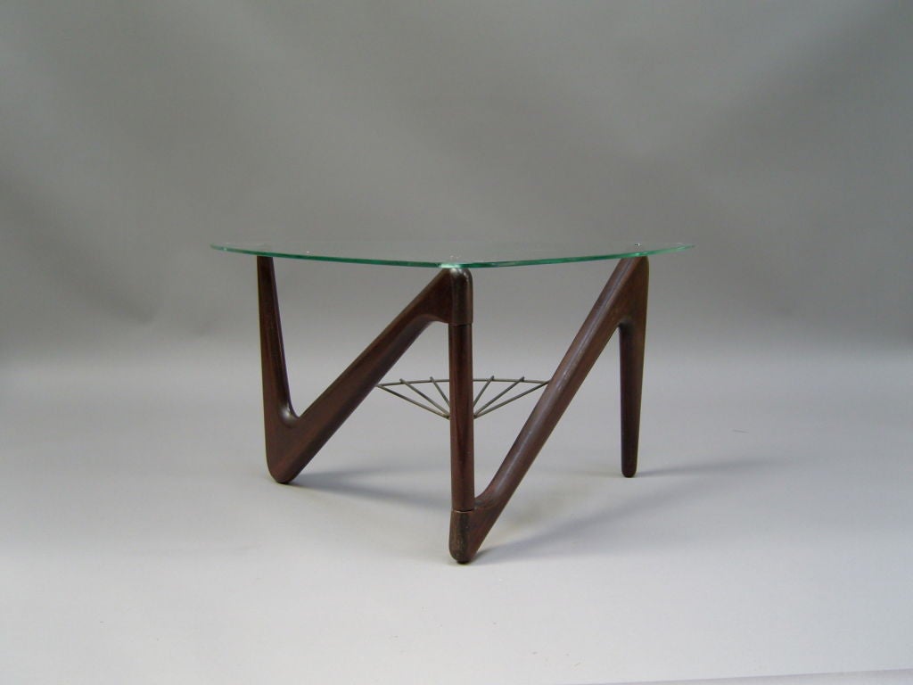 With a mahogany base that supports a triangular glass top, and metal details.
Price is per piece and includes refinishing.