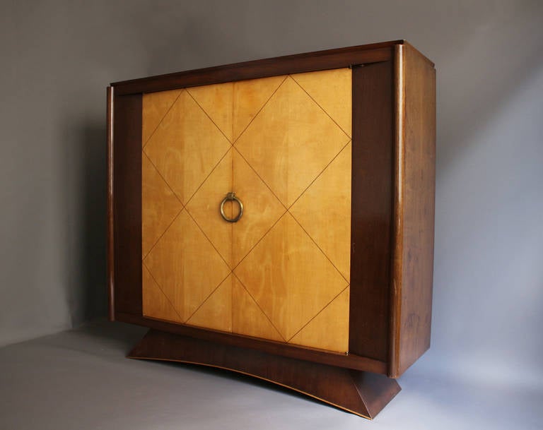 Fine French Art Deco rosewood armoire with two sycamore doors with blackened inlay and brass details.

    