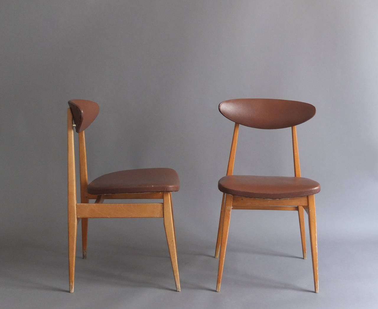 12 French 1950s beechwood and vinyl upholstered side chairs.
Price is per chair.
 