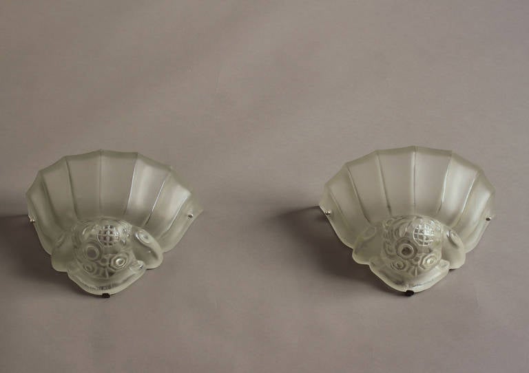 A fine Pair of French Art Deco frosted glass sconces with geometric motif and chrome details by Genet Michon.