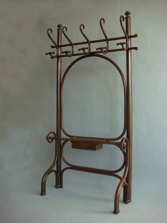 Rare and fine bent beechwood coat rack by Thonet with one draw.  Circa 1920.