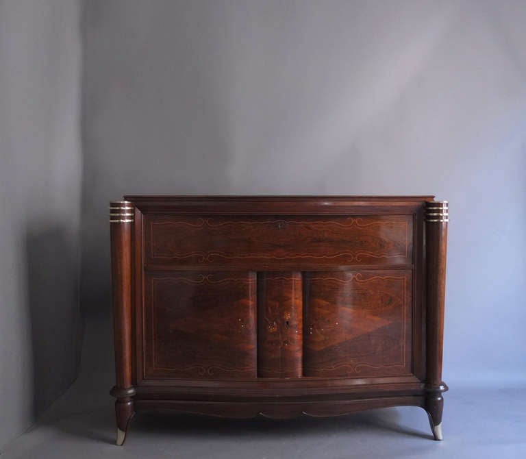 Fine French Art Deco rosewood bar by Segal with marquetry, mother of pearl inlay and chromed details. Two front doors and a top drop door displaying a sycamore and mirrors interior with 2 drawers and brass details.
In the manner of Leleu.
