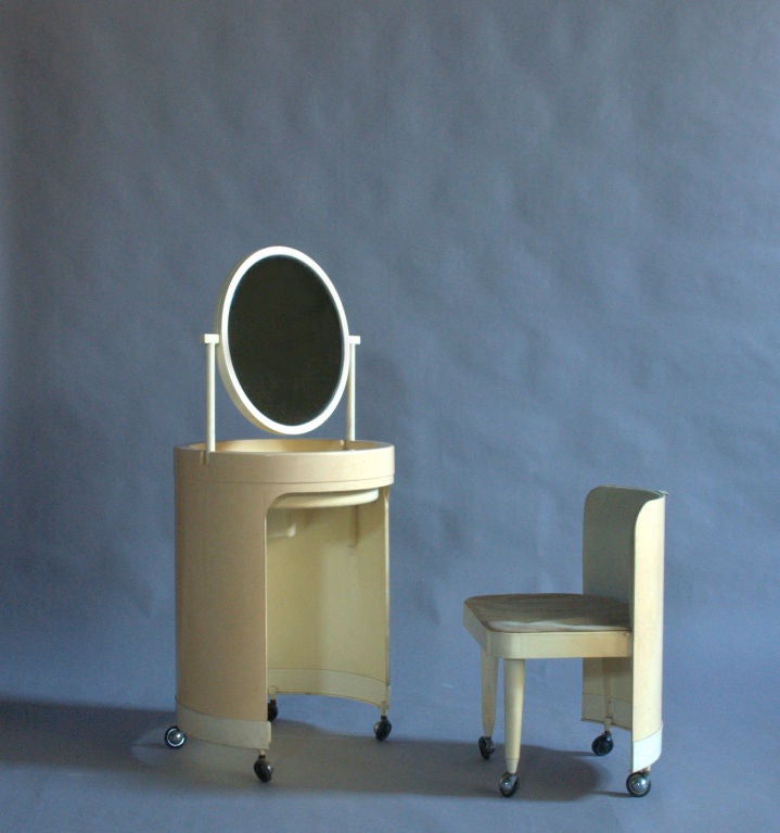 Original compact 1960s Italian rolling plastic vanity and chair with a swivel mirror.