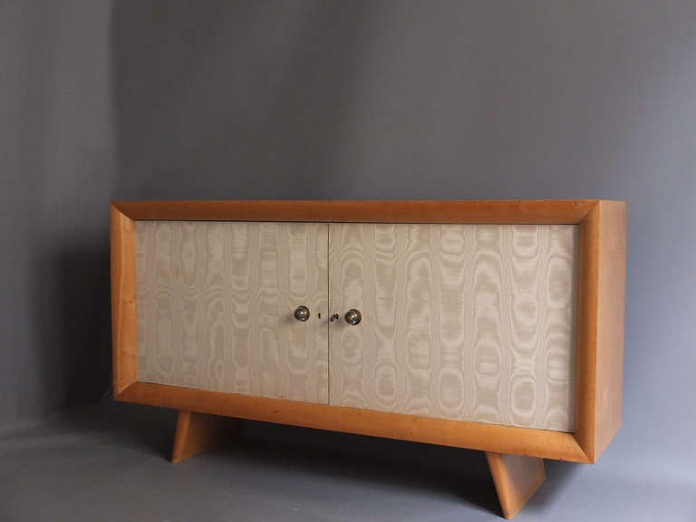 French 1950s sycamore buffet by Suzanne Guiguichon with two original fabric covered doors, brass and glass knobs.
  