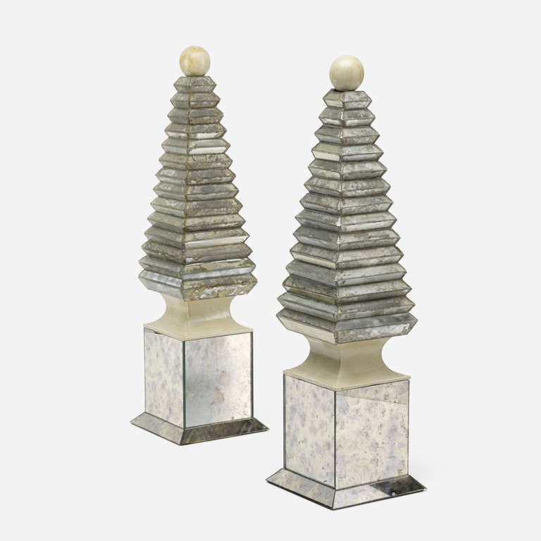 Samuel Marx (1885-1964)
Pair of obelisks in carved and lacquered wood mounted on reverse silver-leafed glass bases with faux-parchment ball finials.
American, circa 1940.