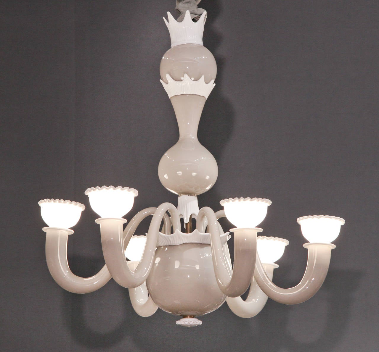 Murano glass chandelier in warm dove gray with delicate lattimo glass decoration and six s-shaped arms terminating in lattimo bobeche cups with crimped edges. The form is derived from seventeenth century Dutch brass chandeliers. 
The collaboration