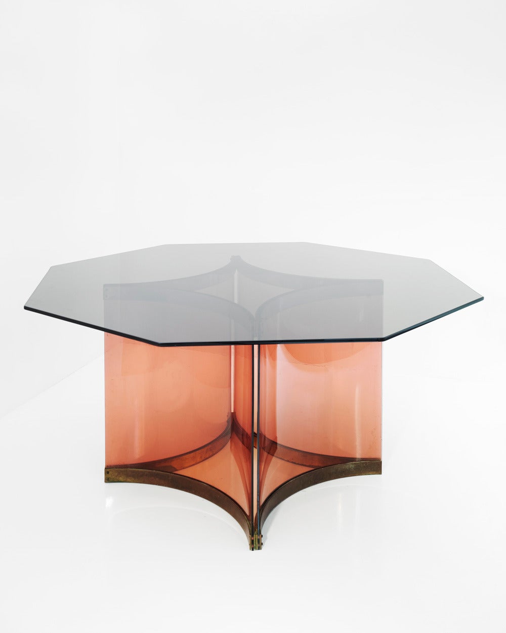 Smoked-glass top octagonal dining table with the designer’s signature Perspex base.