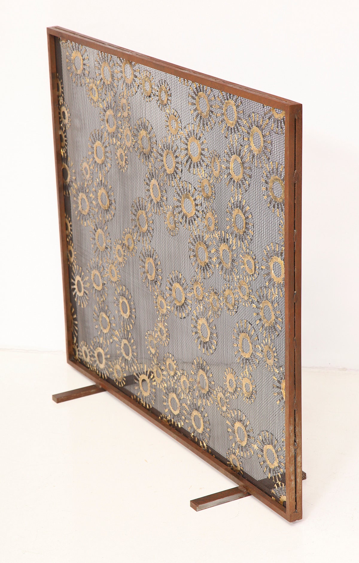 Marie Suri 
The constellation fire screen 
Fire screen with scattered 2.5” and 4” steel medallions with bronze decoration. Mesh backing makes these an excellent choice for wood-burning fireplaces. 
Custom inquiries welcome.
Made to order