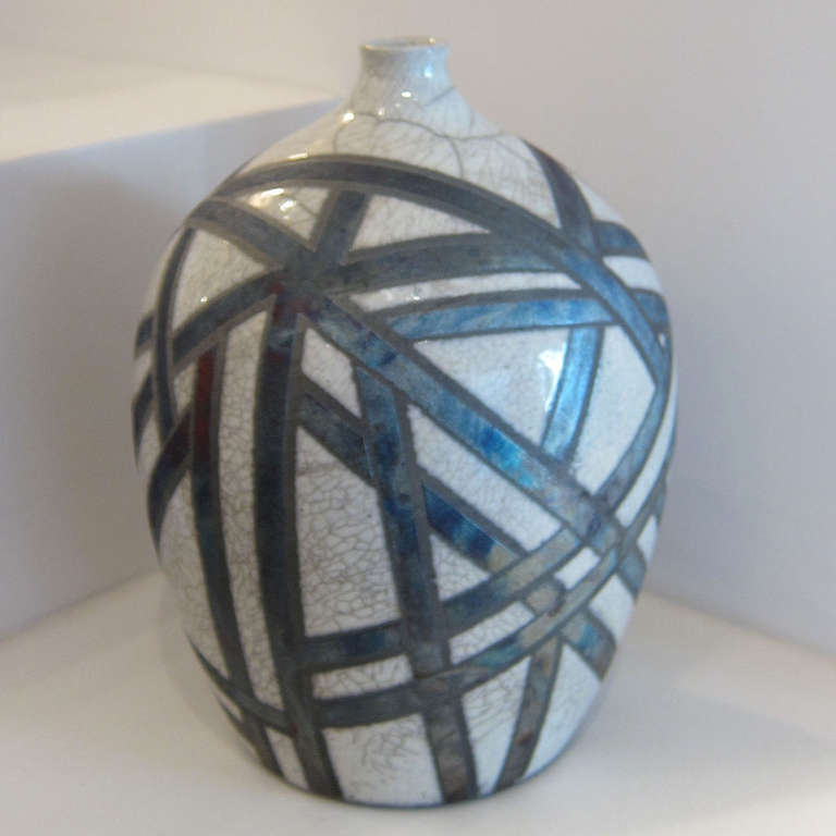 “Blue Snow” Raku Bottle
A Pennsylvania based potter, Deborah Slahta specializes in Raku and stoneware pottery. Slahta uses the vessel form as a three-dimensional canvas, playing with intersecting lines and geometric shapes to create interesting