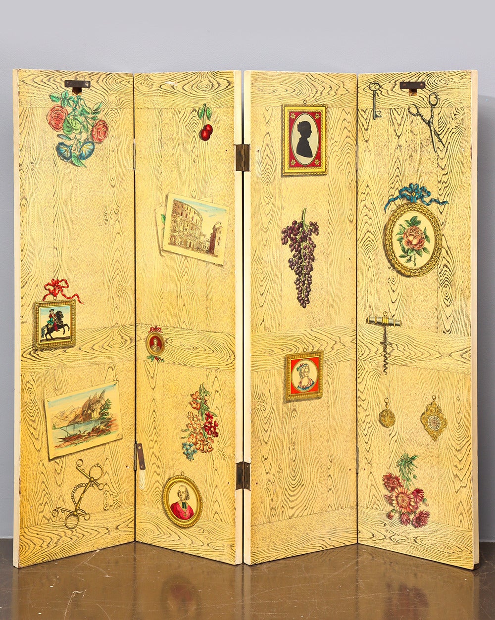 PIERO FORNASETTI (1913-1988)
Four-panel folding screen with transferred lithograph decoration on lacquered wood. One side depicts a classical ruin with cloudy skies and the other features trompe l’oeil framed pictures, flowers, fruits and kitchen