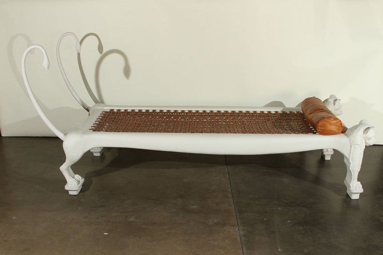 Daybed in carved and white painted wood in the form of lions
with original leather webbing and bolster cushion.
French, c. 1960