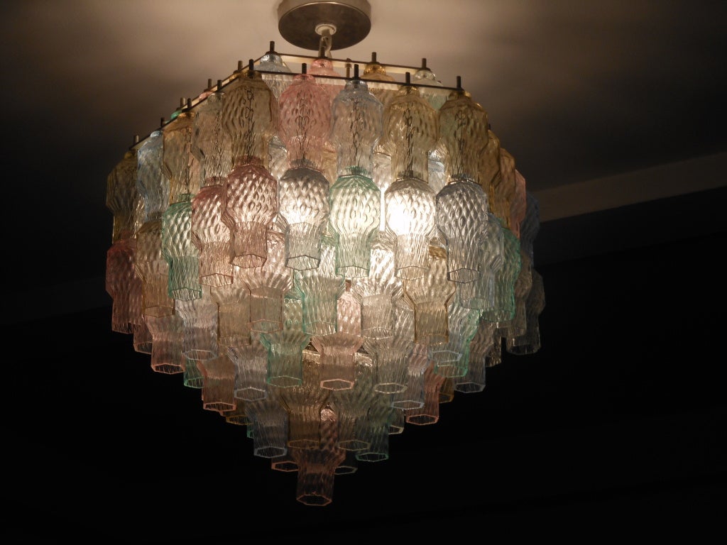 Hanging light with mutlicolored glass globes in pale shades of blue, pink, clear and amber. Each globes is suspended from white-enameled armature.