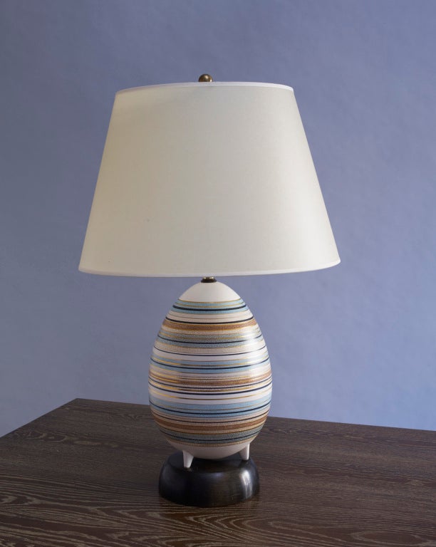 Sascha B (1918-1993)
Ceramic egg form table lamp raised on three tiny feet, mounted on wood base. Glazed and gilded stripe decoration.
Signed: Sascha B