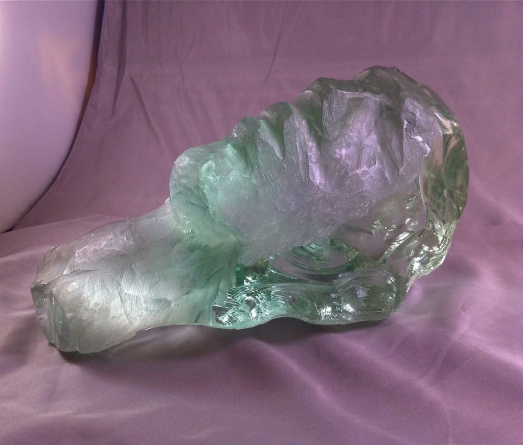 Hand-chiseled glass sculpture of a head by renowned sculptor <br />
Susanne Pascal (b. 1914). Her works, sculpted entirely by hand with hammer & chisel, <br />
are represented internationally in major museums & private collections.